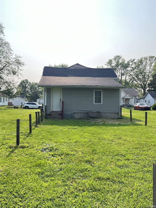 443 S State St, Sullivan, IN 47882 - view of home's exterior with entry steps, a lawn, and roof with shingles