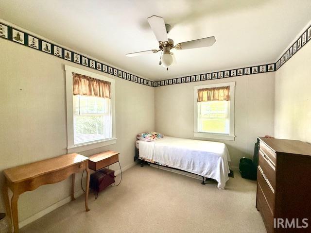 981 Keyser Ln, Richmond, IN 47374 - bedroom with light colored carpet, ceiling fan, and baseboards