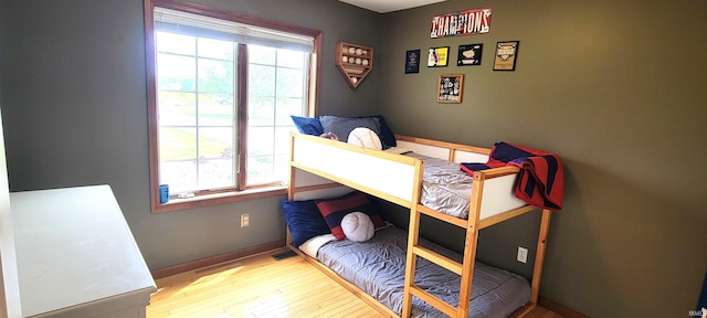 360 E 350 Rd N, Warsaw, IN 46582 - bedroom with multiple windows, wood finished floors, and baseboards