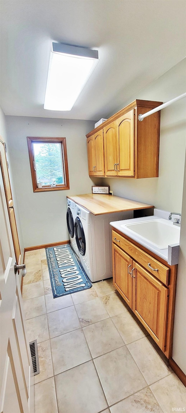 360 E 350 Rd N, Warsaw, IN 46582 - washroom with cabinet space, washing machine and dryer, baseboards, and light tile patterned floors