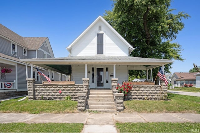 128 E Grant St, Greentown, IN 46936 - country-style home with a porch and a front yard