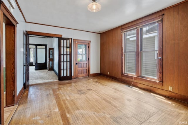 128 E Grant St, Greentown, IN 46936 - spare room with healthy amount of natural light, crown molding, light wood-type flooring, french doors, and wooden walls