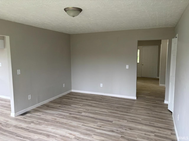 724 Iroquois Dr, Anderson, IN 46012 - unfurnished room with wood finished floors, a textured ceiling, and baseboards