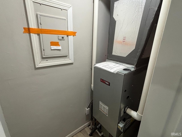 724 Iroquois Dr, Anderson, IN 46012 - utility room featuring heating unit and electric panel