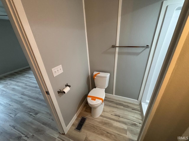 724 Iroquois Dr, Anderson, IN 46012 - bathroom with toilet, wood finished floors, and baseboards