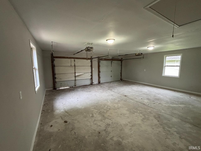 724 Iroquois Dr, Anderson, IN 46012 - garage featuring a garage door opener and baseboards