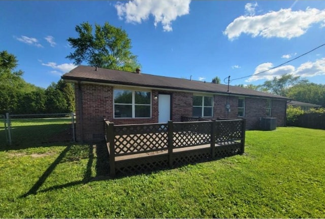 724 Iroquois Dr, Anderson, IN 46012 - rear view of house with brick siding, a deck, and central AC unit