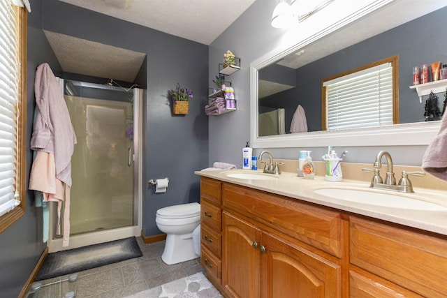 1617 Bennington Dr, Mishawaka, IN 46544 - full bath with double vanity, a stall shower, toilet, baseboards, and a textured ceiling