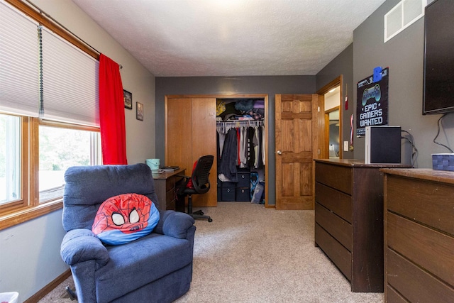 1617 Bennington Dr, Mishawaka, IN 46544 - bedroom featuring a desk, light carpet, a closet, and a textured ceiling