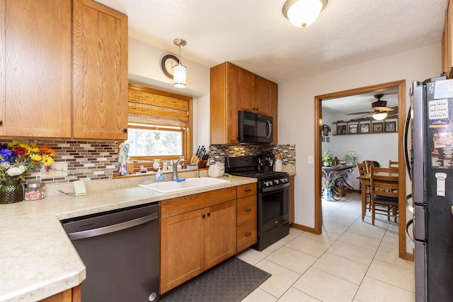 1617 Bennington Dr, Mishawaka, IN 46544 - kitchen with black appliances, a sink, light countertops, light tile patterned flooring, and decorative backsplash