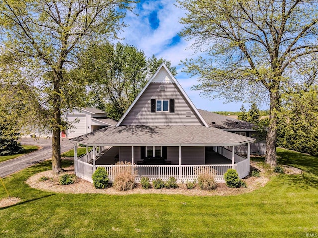 7782 S Warren Rd, Warren, IN 46792 - view of front of home featuring covered porch, a front lawn, and roof with shingles