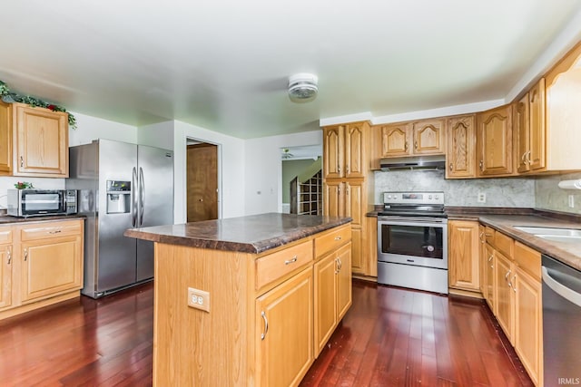 7782 S Warren Rd, Warren, IN 46792 - kitchen with appliances with stainless steel finishes, dark countertops, and dark wood-type flooring