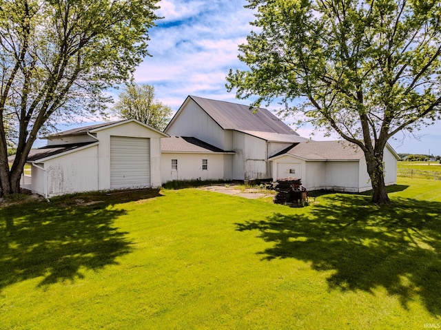 7782 S Warren Rd, Warren, IN 46792 - rear view of property featuring a yard