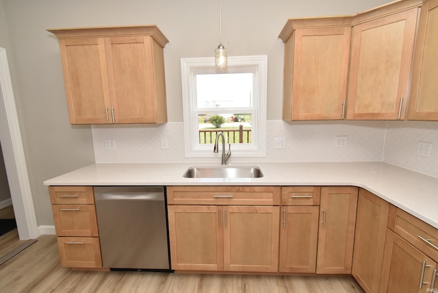 4831 N 400 W, Earl Park, IN 47942 - kitchen with stainless steel dishwasher, a sink, light wood finished floors, tasteful backsplash, and light countertops