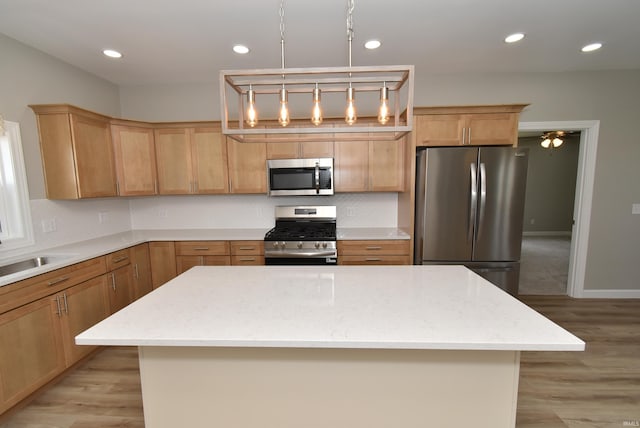 4831 N 400 W, Earl Park, IN 47942 - kitchen featuring appliances with stainless steel finishes, tasteful backsplash, light wood finished floors, a sink, and a center island