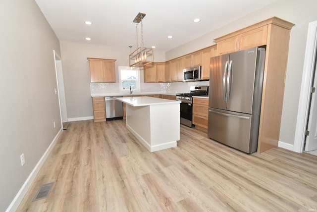 4831 N 400 W, Earl Park, IN 47942 - kitchen featuring appliances with stainless steel finishes, light brown cabinetry, light countertops, light wood-style floors, and decorative backsplash