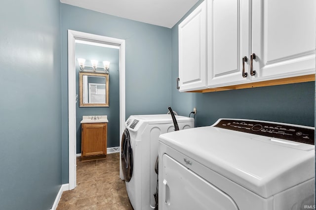 211 Condo St, Monticello, IN 47960 - laundry room featuring independent washer and dryer, baseboards, and cabinet space