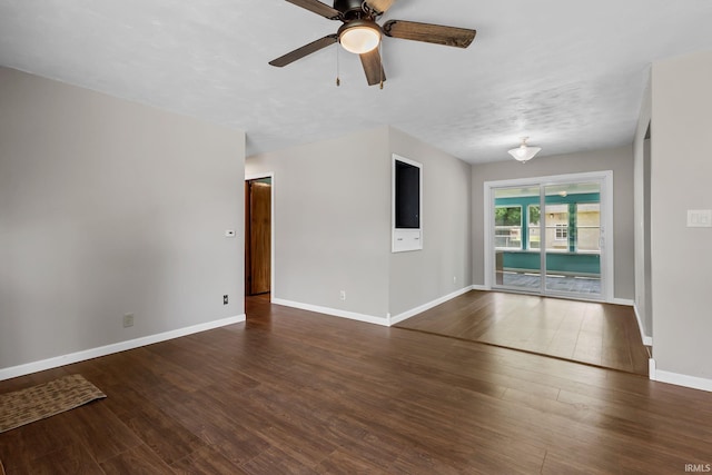211 Condo St, Monticello, IN 47960 - empty room featuring ceiling fan, wood finished floors, and baseboards