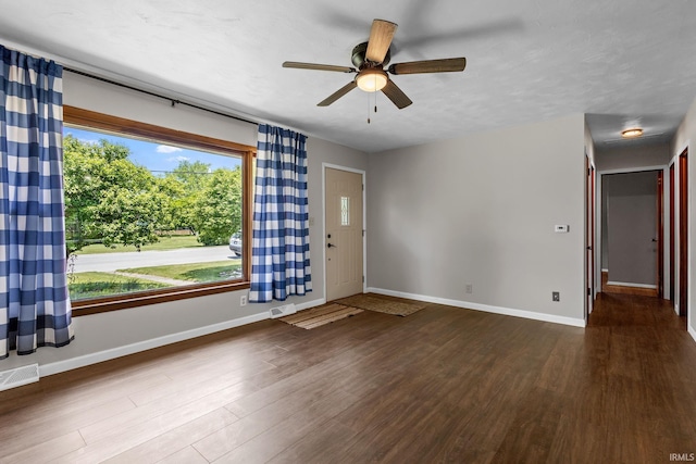 211 Condo St, Monticello, IN 47960 - foyer featuring wood finished floors, baseboards, and ceiling fan