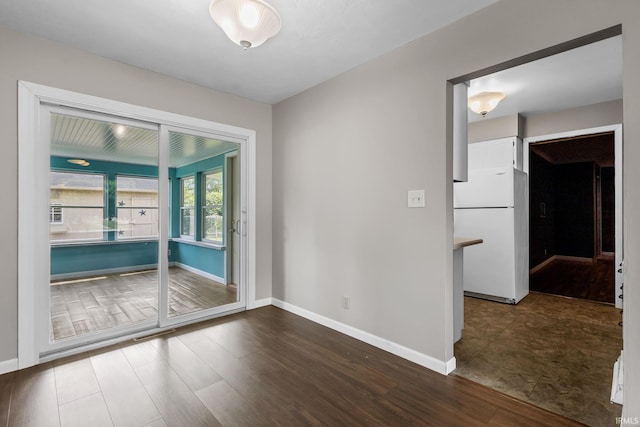 211 Condo St, Monticello, IN 47960 - spare room featuring dark wood finished floors and baseboards