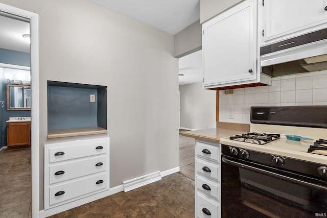 211 Condo St, Monticello, IN 47960 - kitchen with gas range oven, light countertops, tasteful backsplash, white cabinetry, and baseboards
