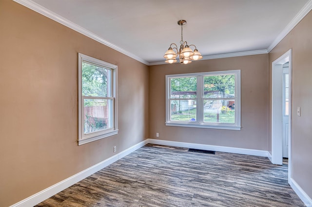 3017 E Walnut St, Evansville, IN 47714 - unfurnished room featuring healthy amount of natural light, a chandelier, dark wood finished floors, baseboards, and crown molding