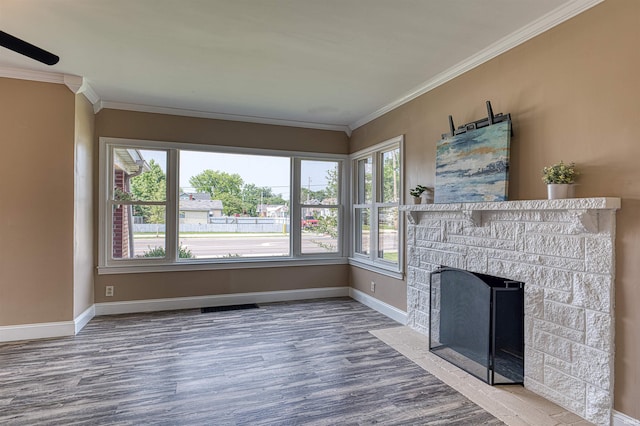 3017 E Walnut St, Evansville, IN 47714 - unfurnished living room featuring wood finished floors, crown molding, baseboards, and a stone fireplace