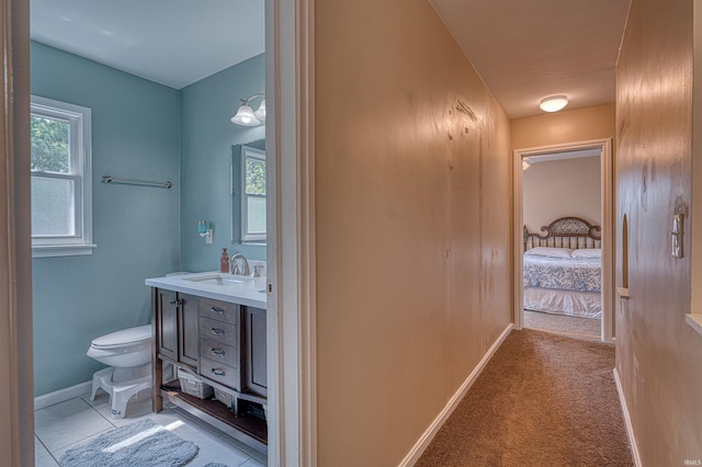 3017 E Walnut St, Evansville, IN 47714 - bathroom with vanity, toilet, baseboards, and ensuite bathroom