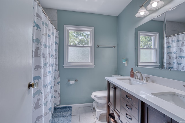 3017 E Walnut St, Evansville, IN 47714 - bathroom with toilet, plenty of natural light, double vanity, and baseboards