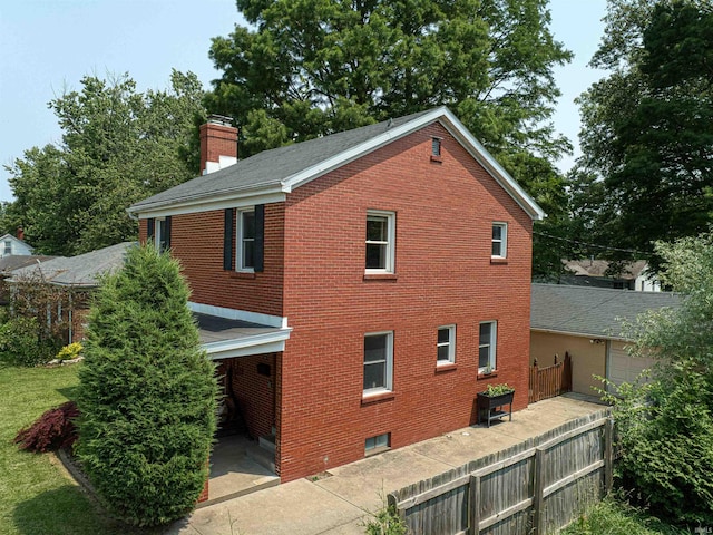 3017 E Walnut St, Evansville, IN 47714 - view of home's exterior featuring brick siding and a chimney