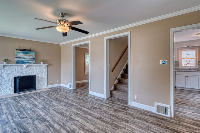 3017 E Walnut St, Evansville, IN 47714 - unfurnished living room with wood finished floors, plenty of natural light, a sink, ceiling fan, and crown molding