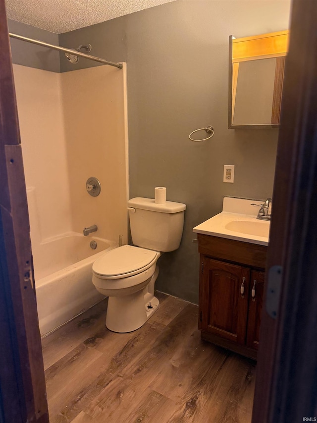 1406 N Philips St, Kokomo, IN 46901 - full bathroom with wood finished floors, vanity, shower / washtub combination, toilet, and a textured ceiling