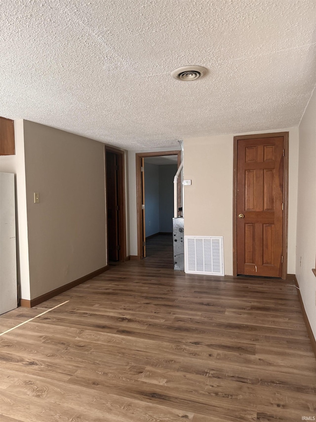 1406 N Philips St, Kokomo, IN 46901 - empty room with a textured ceiling, wood finished floors, and baseboards