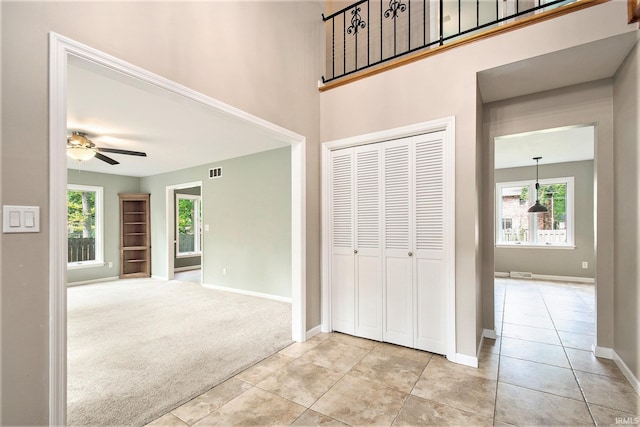 54559 Whispering Oak Dr, Mishawaka, IN 46545 - corridor featuring baseboards, light tile patterned floors, and light colored carpet