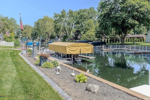 11382 N Biscayne Ln, Cromwell, IN 46732 - dock area featuring boat lift, a lawn, view of wooded area, and a water view
