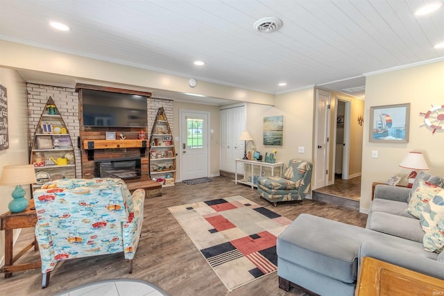 11382 N Biscayne Ln, Cromwell, IN 46732 - living room with a large fireplace, wood finished floors, ornamental molding, recessed lighting, and baseboards
