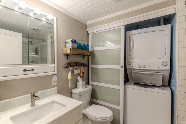 11382 N Biscayne Ln, Cromwell, IN 46732 - bathroom featuring stacked washer / drying machine, crown molding, vanity, toilet, and a stall shower