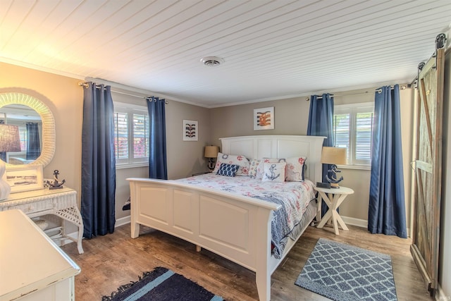 11382 N Biscayne Ln, Cromwell, IN 46732 - bedroom with ornamental molding, multiple windows, wood finished floors, and baseboards