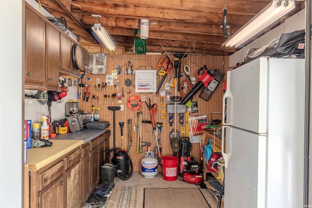 11382 N Biscayne Ln, Cromwell, IN 46732 - basement with freestanding refrigerator and a workshop area