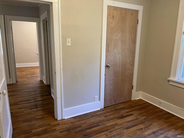 1311 S 31st St, South Bend, IN 46615 - unfurnished bedroom with dark wood-type flooring, baseboards, and a closet