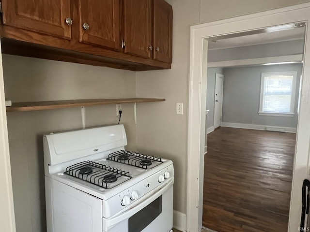 1311 S 31st St, South Bend, IN 46615 - kitchen featuring white gas stove, wood finished floors, baseboards, and brown cabinetry