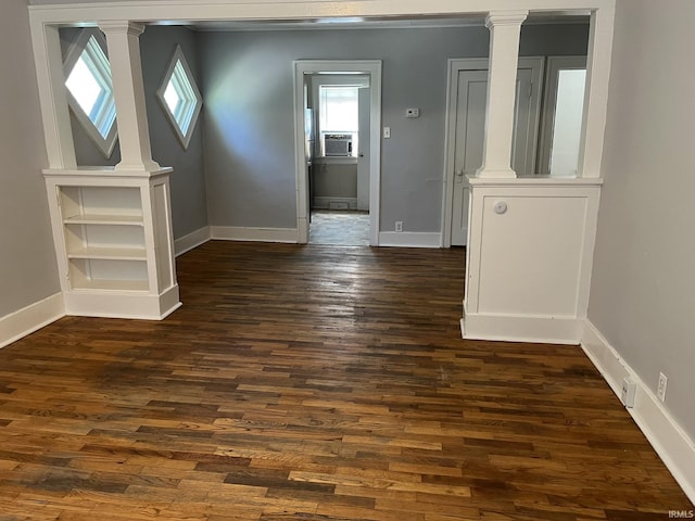 1311 S 31st St, South Bend, IN 46615 - spare room with decorative columns, dark wood finished floors, baseboards, and cooling unit