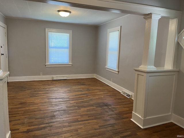 1311 S 31st St, South Bend, IN 46615 - empty room featuring ornate columns, crown molding, dark wood finished floors, and baseboards