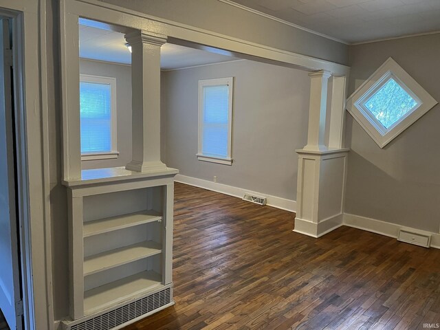 1311 S 31st St, South Bend, IN 46615 - spare room featuring decorative columns, ornamental molding, dark wood finished floors, and baseboards