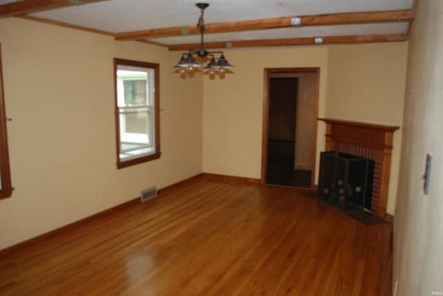 2310 Homewood Ave, Mishawaka, IN 46544 - unfurnished living room with light wood-style floors, beam ceiling, a fireplace, baseboards, and a chandelier