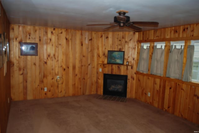 2310 Homewood Ave, Mishawaka, IN 46544 - living room with a ceiling fan, wooden walls, carpet, and a glass covered fireplace