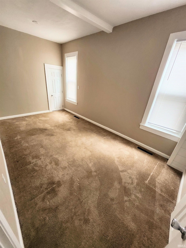436 E Taber St, Fort Wayne, IN 46803 - carpeted empty room with beam ceiling and baseboards