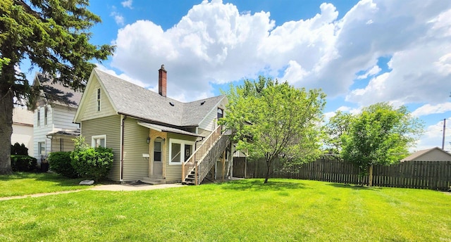436 E Taber St, Fort Wayne, IN 46803 - back of property with entry steps, a chimney, and roof with shingles