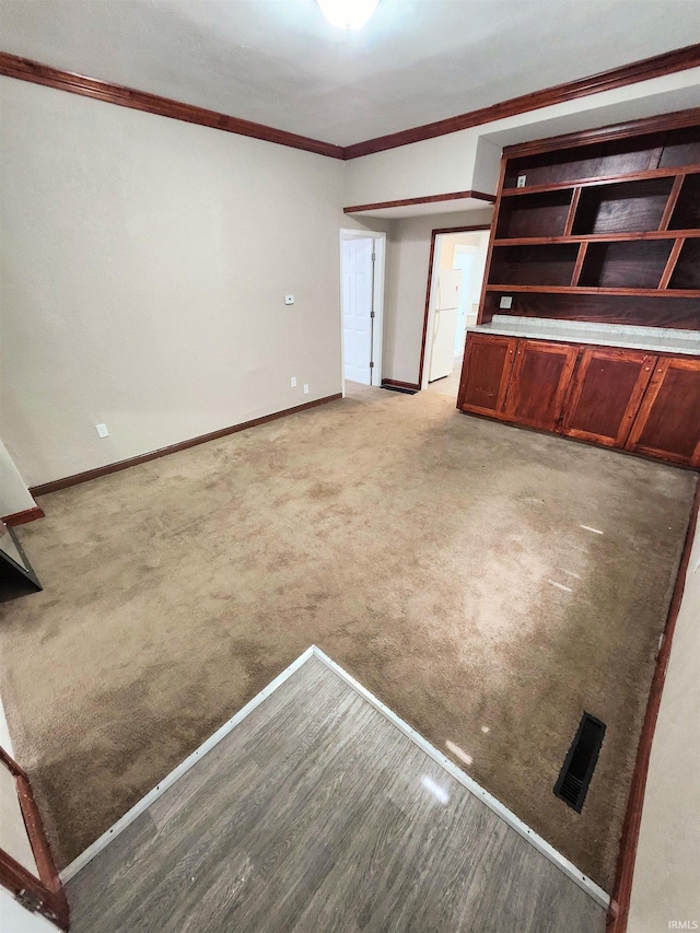 436 E Taber St, Fort Wayne, IN 46803 - unfurnished living room with crown molding, baseboards, and light carpet