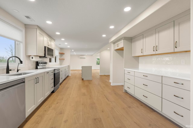 11136 N 200 W, Ossian, IN 46777 - kitchen with stainless steel appliances, a sink, recessed lighting, decorative backsplash, and light wood-type flooring